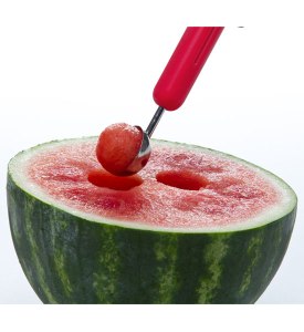 watermelon getting balls scooped out of it with a melon baller