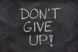 text on a chalkboard that reads Don't Give Up!