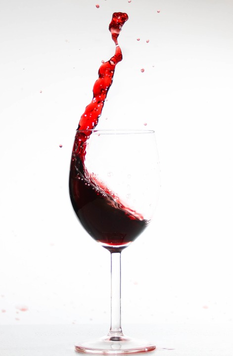A spilling glass of red wine 