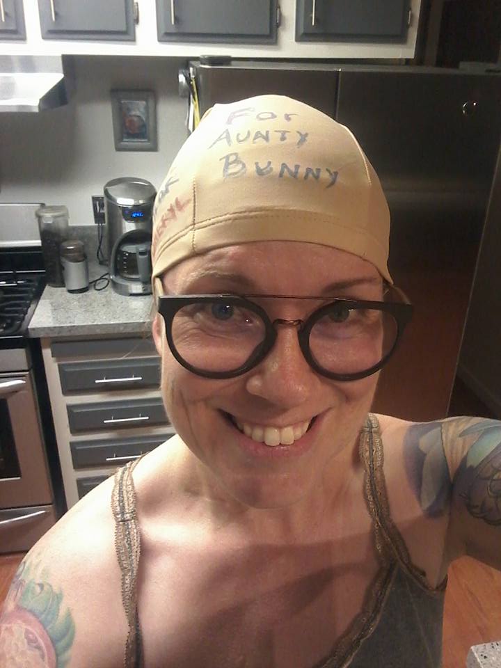 Lisa in a skull cap for breast cancer awareness labeled "For Aunty Bunny"