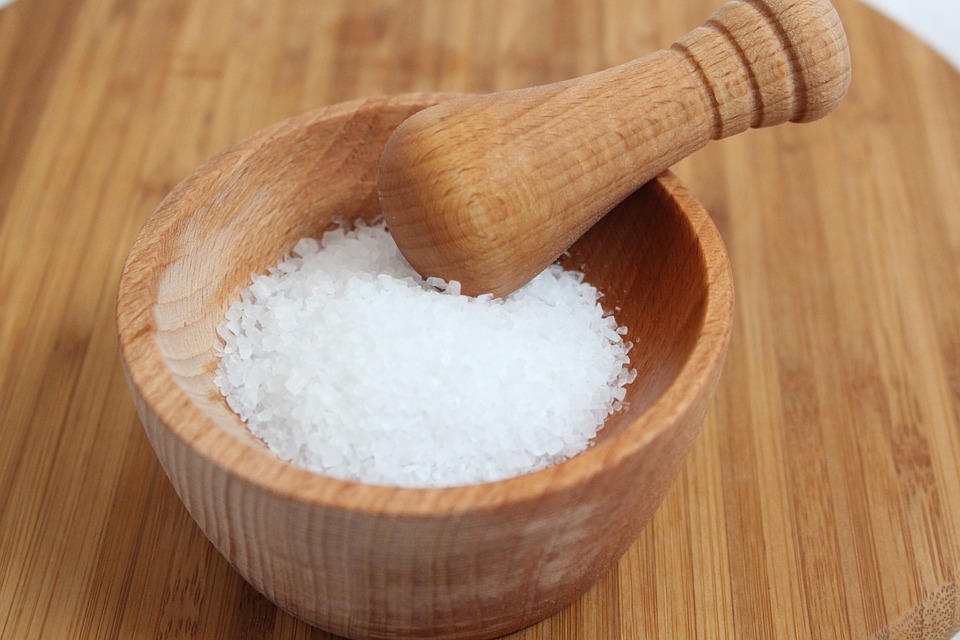 wooden mortar and pestle filled with salt