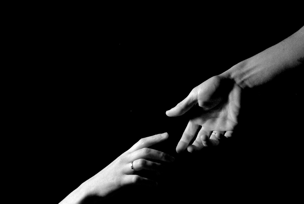 Two hands reaching out for each other