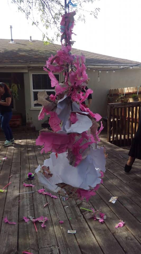 destroyed pinata that was in the shape of a uterus, now in tatters
