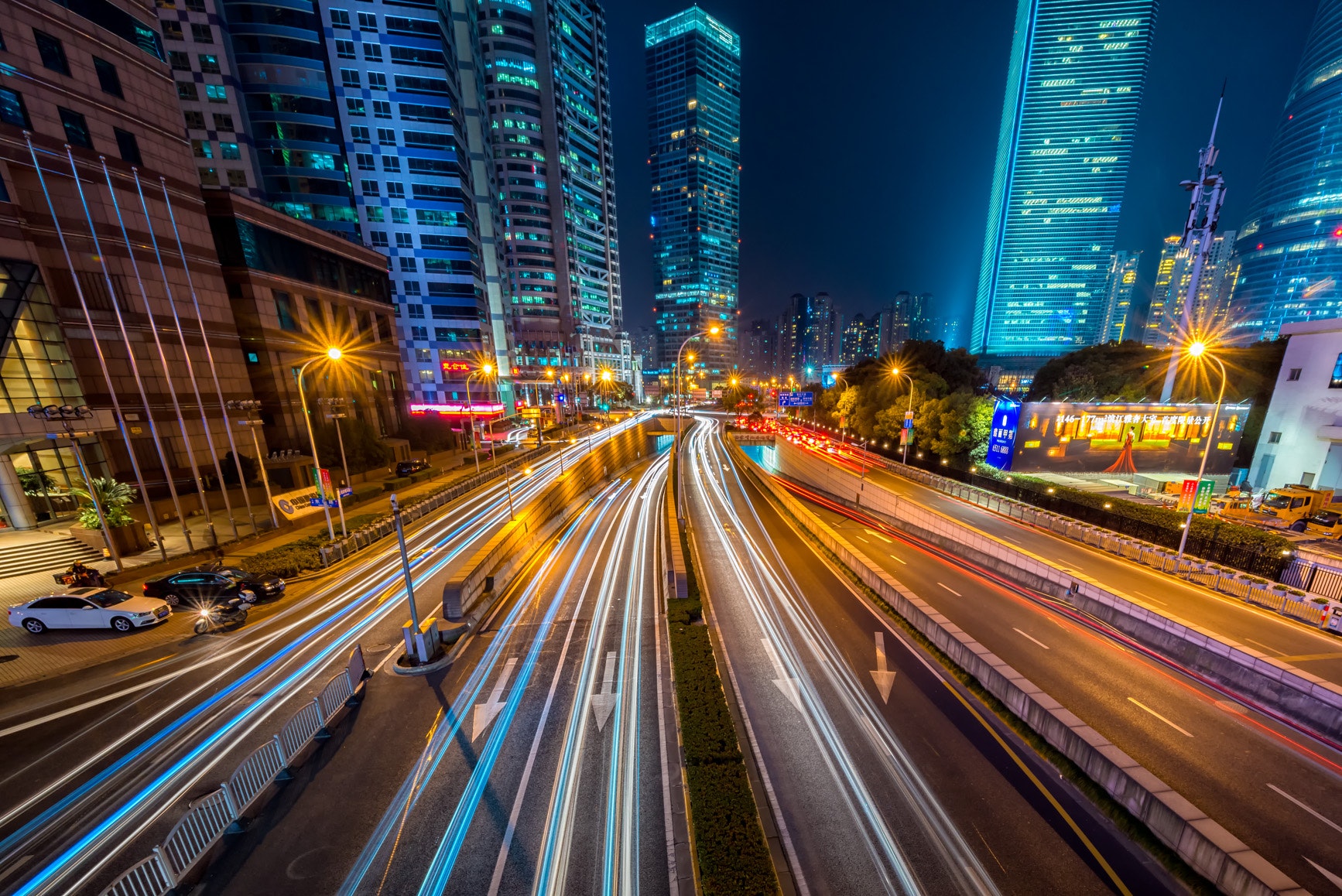 Cityscape at night time with blurred lights of cars driving by