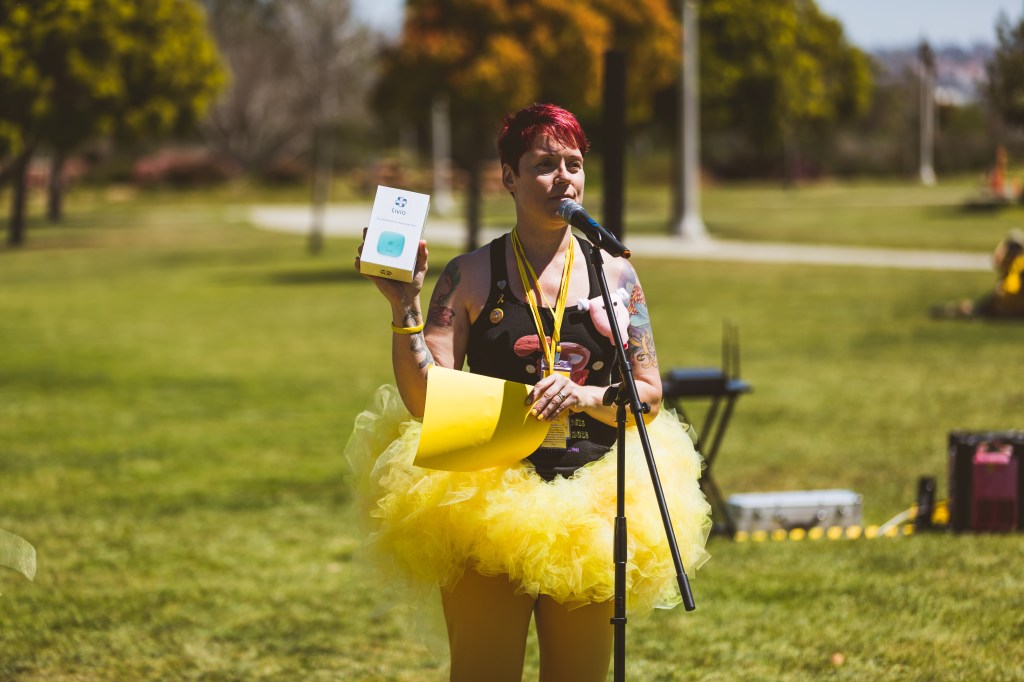 Lisa Howard holding up Liva unit for Bingo prize