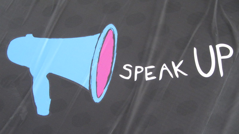 Banner with megaphone and words "Speak Up" next to ti