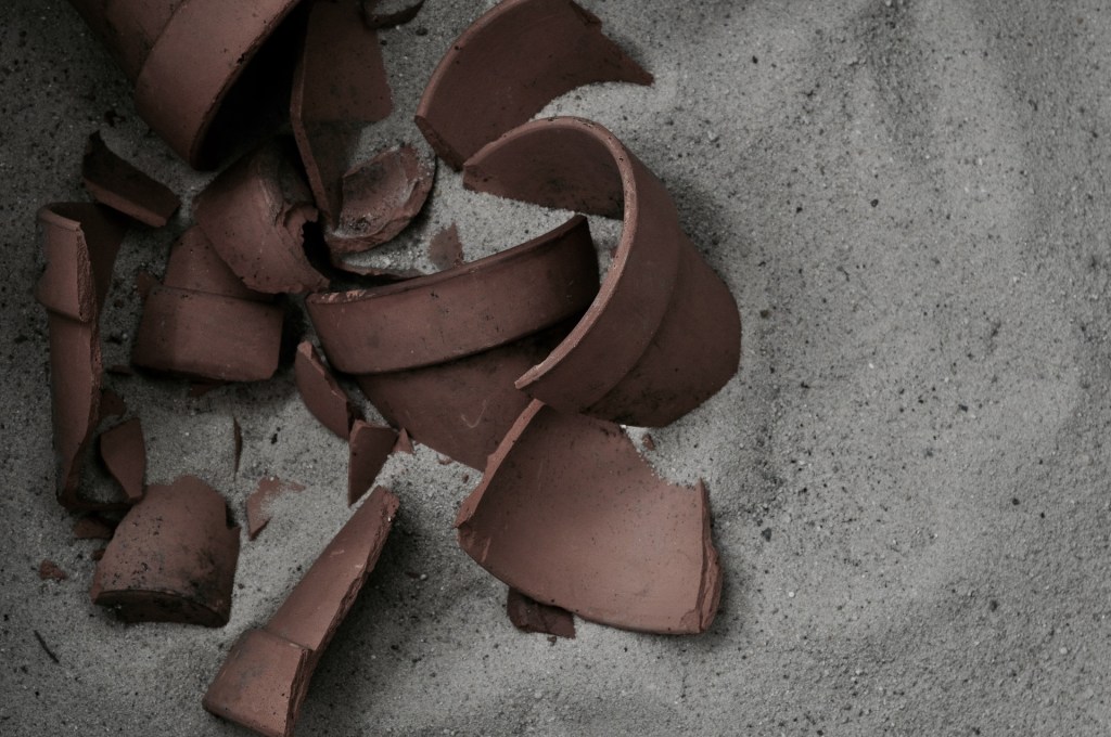 broken terracotta pot in the sand