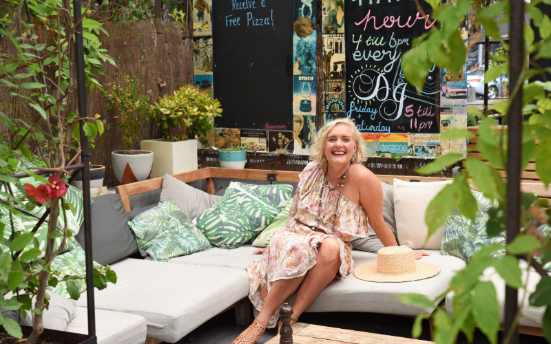 Woman sitting on couch outside